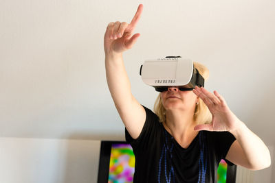 Middle-aged woman looking through virtual reality glasses