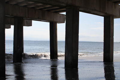 Scenic view of sea against sky seen through pier