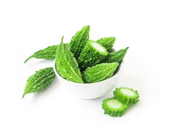 Close-up of green chili pepper against white background