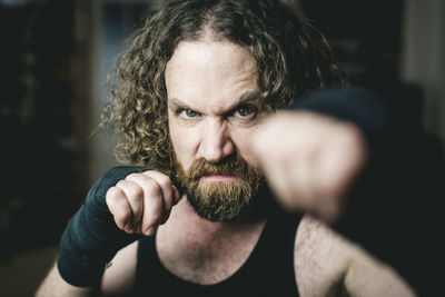 Portrait of angry man punching 