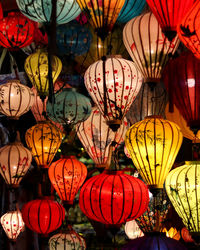 Low angle view of illuminated lanterns hanging at night