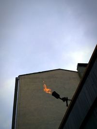 Low angle view of man hand against sky