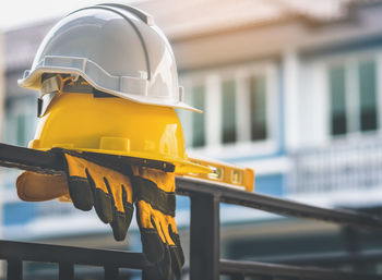 Close-up of yellow railing against built structure