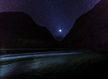 Scenic view of mountain against sky at night