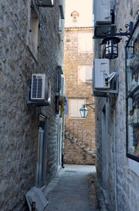 Alley amidst houses in city