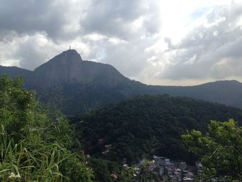 Scenic view of mountains against cloudy sky