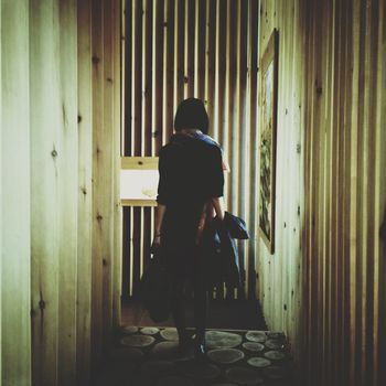 Rear view of woman walking in corridor