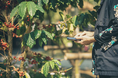 Midsection of woman using mobile phone