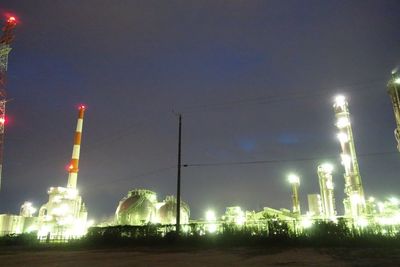 Low angle view of illuminated lights against sky at night