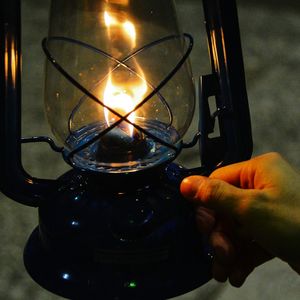 Close-up of hand holding candles