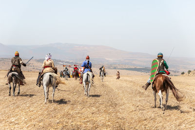 Group of people riding horses