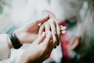 Close-up of couple holding hands