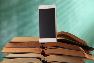 Close-up of mobile phone on book