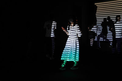 Full length of man standing in dark room