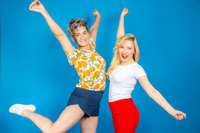 Low angle view of woman against blue background