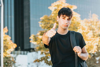 Portrait of young man standing outdoors