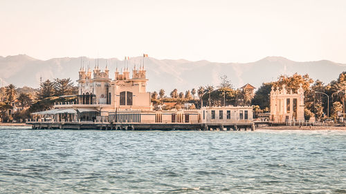 View of buildings in city against clear sky