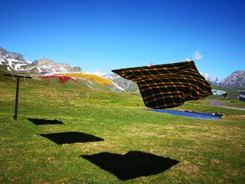 Scenic view of field against clear blue sky