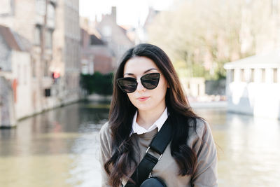 Young beautiful brunette on a spring day in the city.