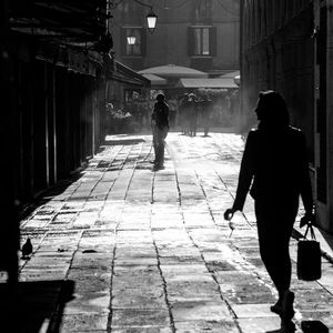Rear view of people walking on street