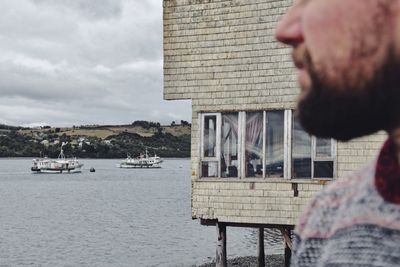 Close-up of man against sea against sky