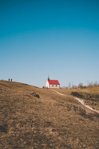Walberla chapelle on field against clear blue sky on the mountain anlog look
