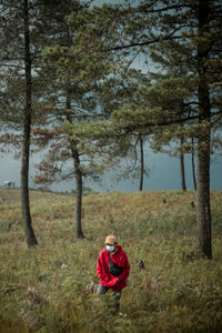 Portrait of man on field in forest