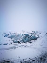 Scenic view of glacier against clear sky during winter