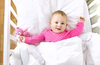 Cute baby boy sleeping on bed at home