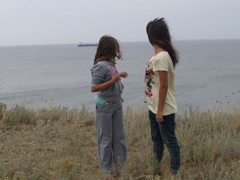 Full length of friends on beach