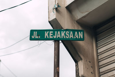 Low angle view of road sign against sky