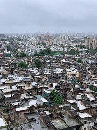 High angle view of buildings in city against sky