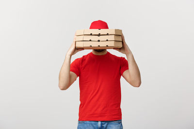 Midsection of man holding toy blocks against white background