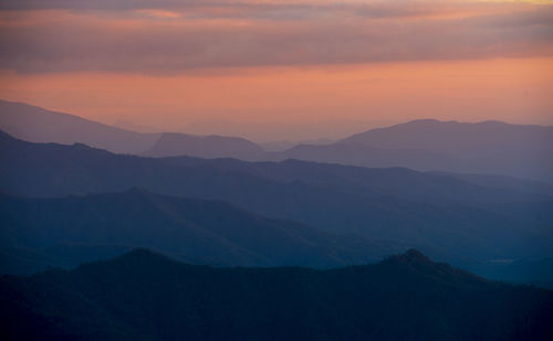 Scenic view of silhouette mountains against sky during sunset