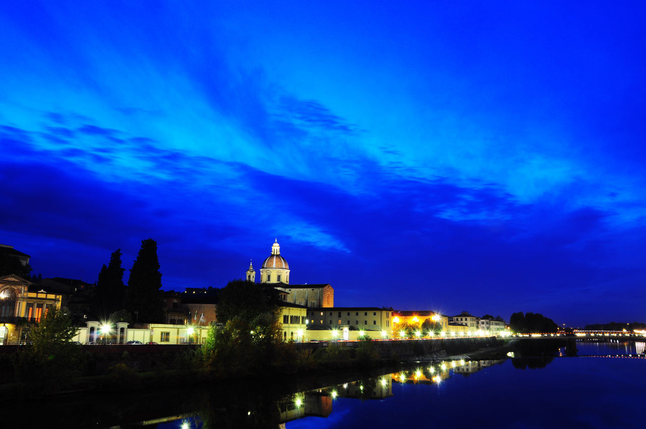 ILLUMINATED BUILDINGS IN CITY AT NIGHT