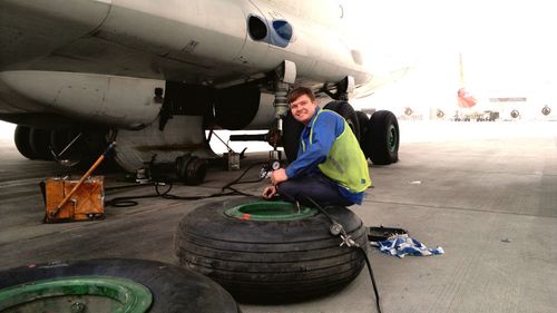 Portrait of man repairing airplane