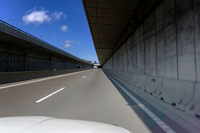 Empty road along built structures