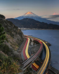 High angle view of light trails by road against sky