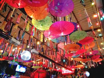 Low angle view of illuminated lanterns hanging in city at night