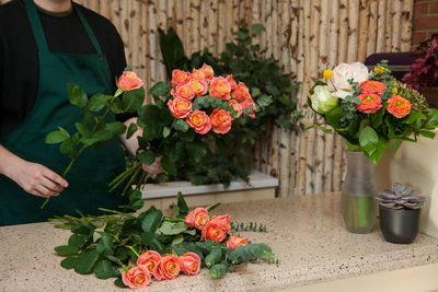 Florist arranging a bouquet of roses
