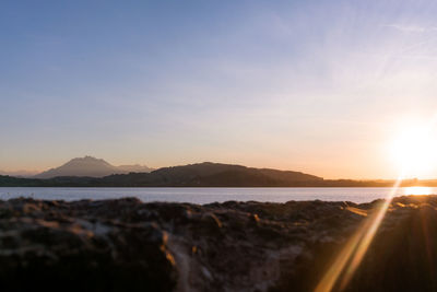 Scenic view of lake zug against sky during sunset