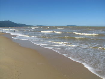 Scenic view of beach against clear sky