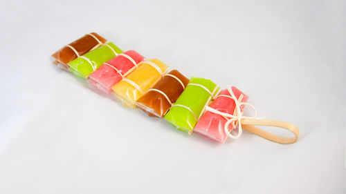 High angle view of multi colored pencils on white background