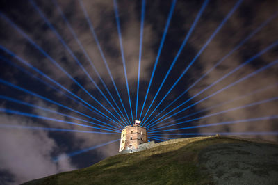 Low angle view of illuminated building against blue sky