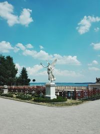 Statue of building against cloudy sky