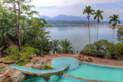 Scenic view of swimming pool by lake against sky