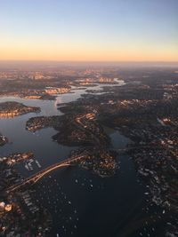 Aerial view of cityscape against sky during sunset