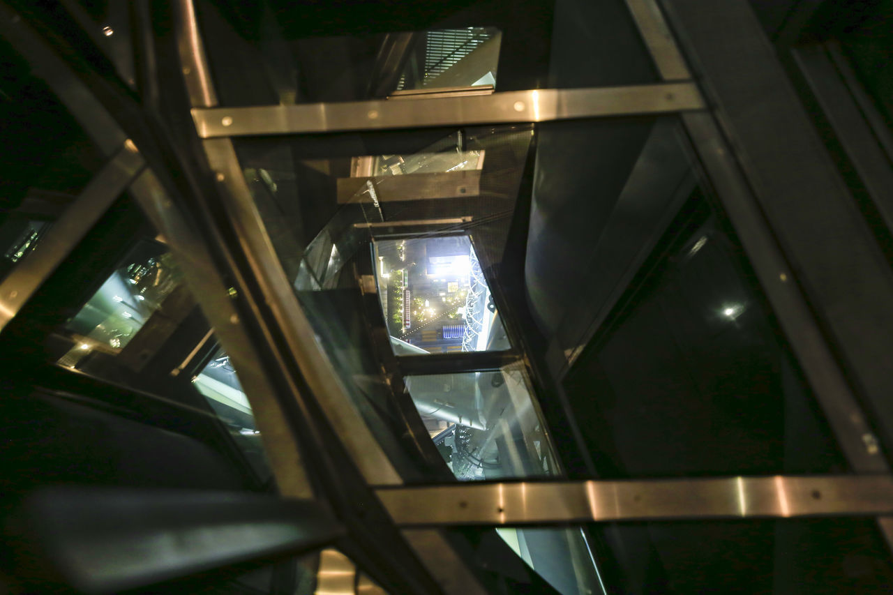 LOW ANGLE VIEW OF ILLUMINATED BUILDING SEEN THROUGH WINDOW