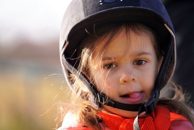 Portrait of baby girl horse rider in helmet