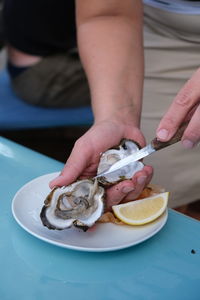 Opening oysters with a knife